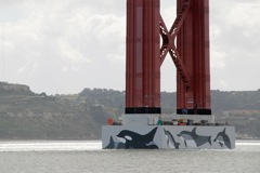 More dolphins painted on the April 25th bridge tower base-Lisbon